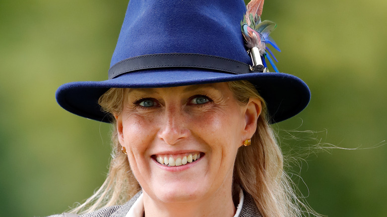 Countess of Wessex smiling in blue hat