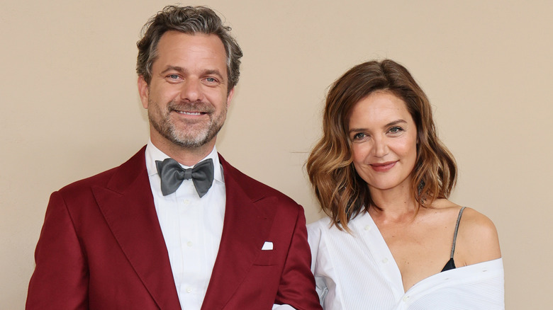 Joshua Jackson and Katie Holmes smiling while posing at an event together