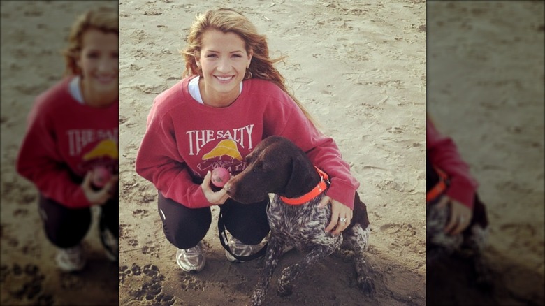 Naomie on the beach with her dog in 2013