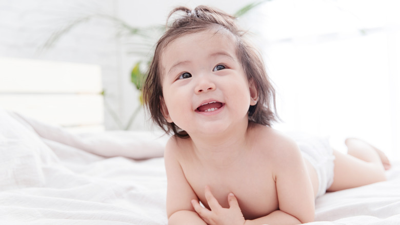 Baby in diaper, smiling