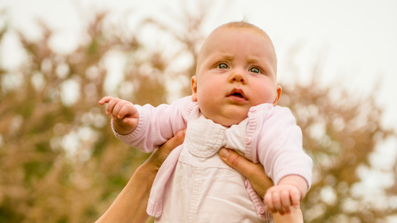 Baby girl being held up