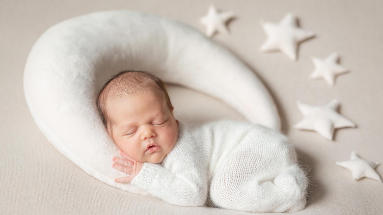 Baby girl surrounded by stars