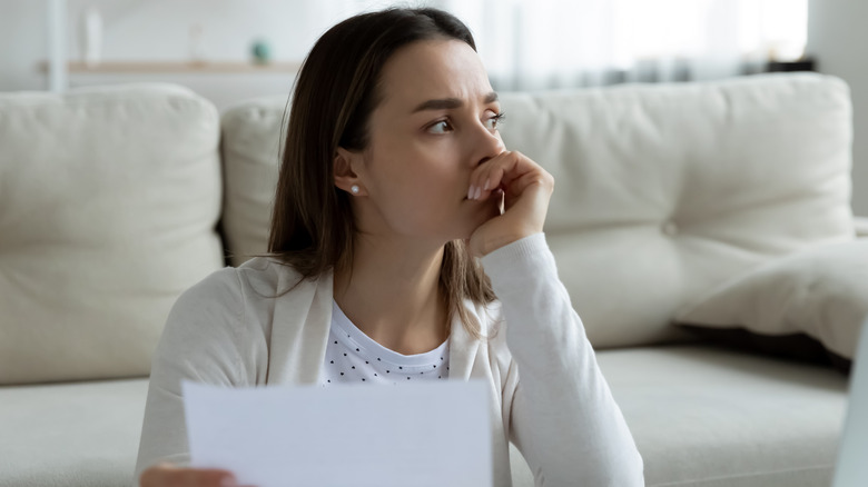 woman stressed hand to chin