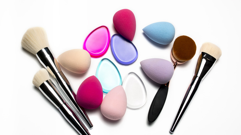 Various tools to apply makeup with on a white background 