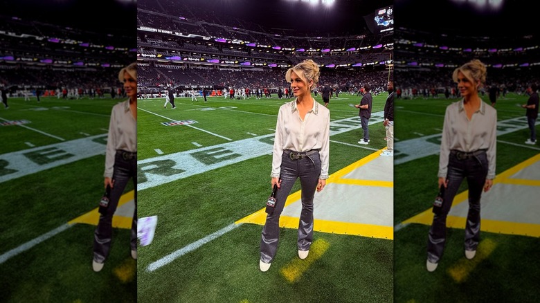 Laura Rutledge posing on the sidelines of a football stadium.