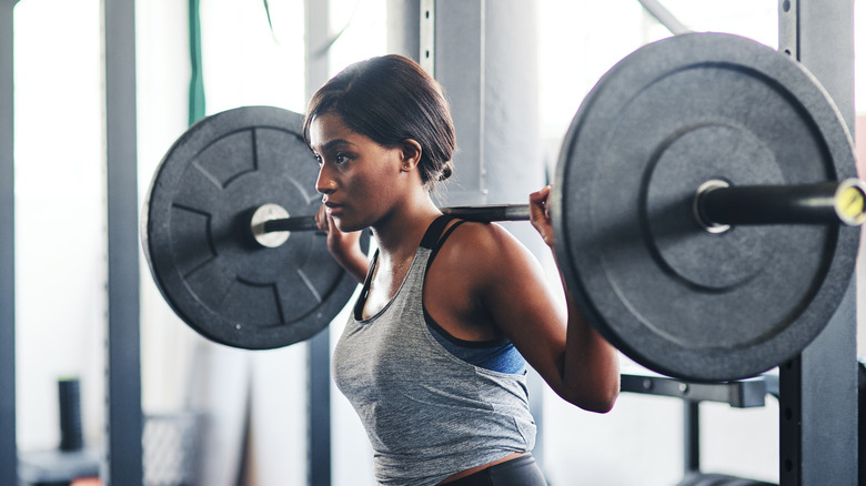 woman carrying barbell