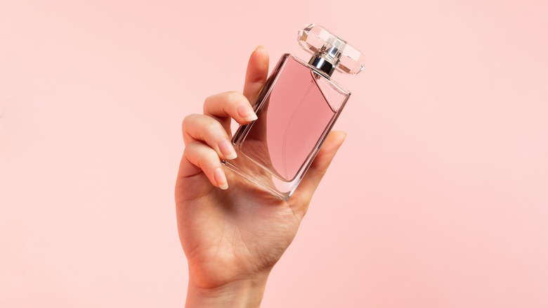 Hand holding perfume