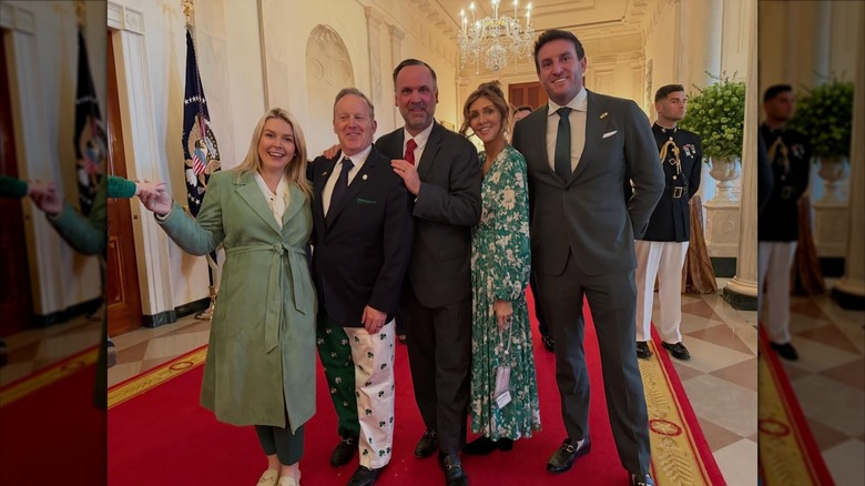 Karoline Leavitt and Sean Spicer posing with others