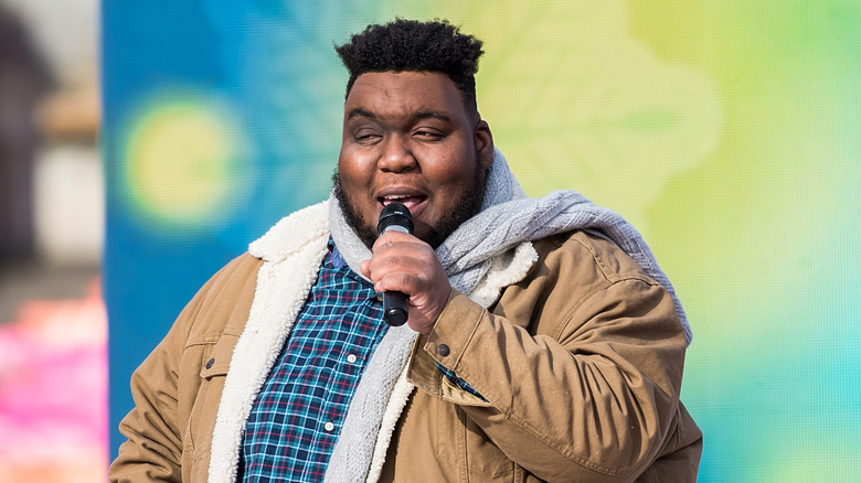 Willie Spence speaking into a microphone