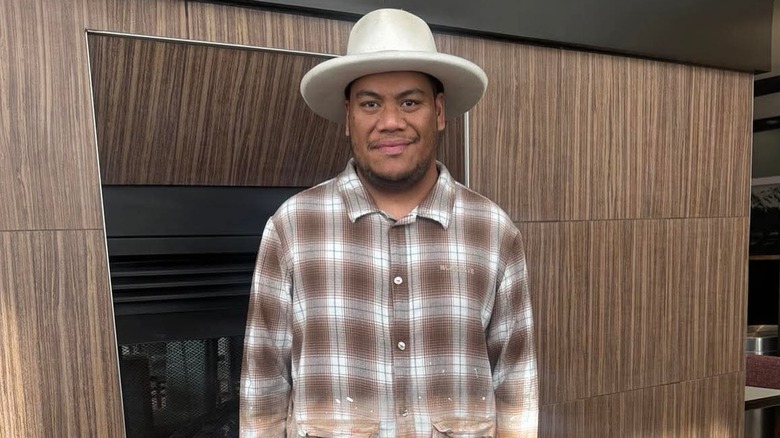 Arthur Folasa Ah Loo in plaid shirt and hat