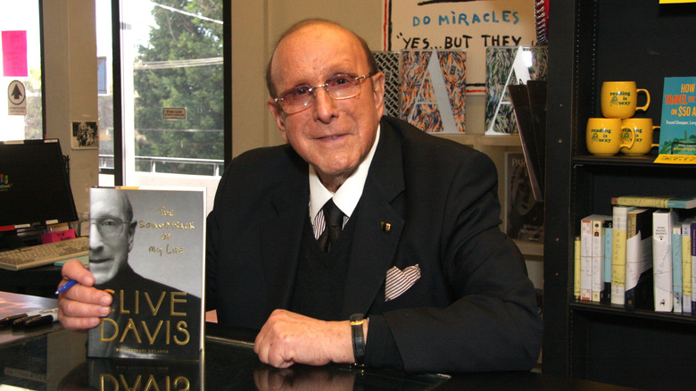 Clive Davis holding his memoir in 2013 at book signing