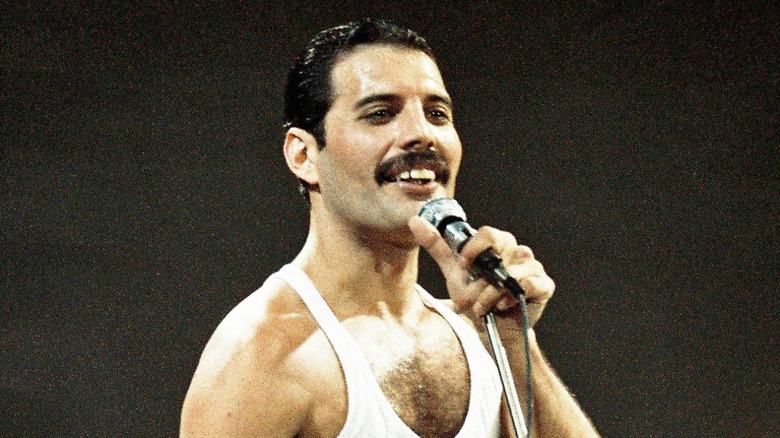 Freddie Mercury singing into mic at Live Aid in 1985