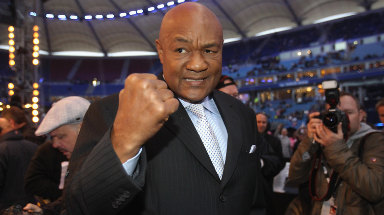 George Foreman flexing his fist at the camera