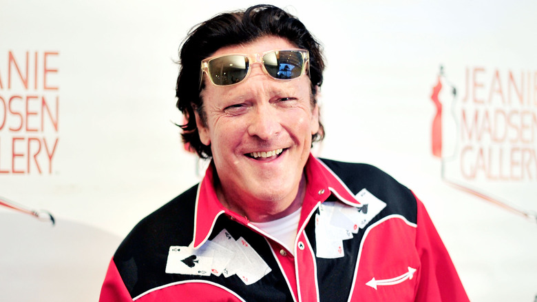 Michael Madsen smiling for photos with sunglasses on his head