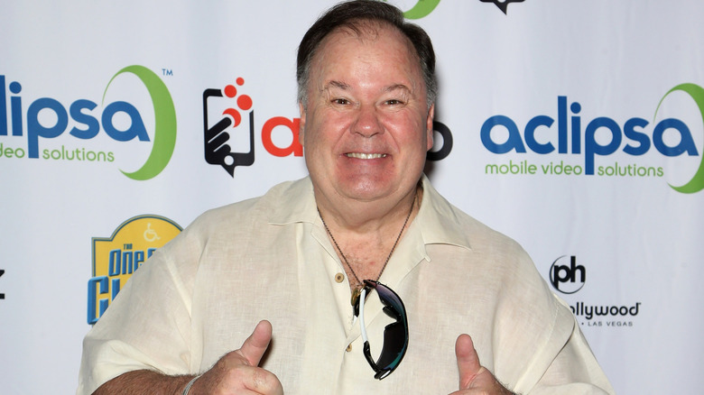 Dennis Haskins smiling and giving the camera a double thumbs up