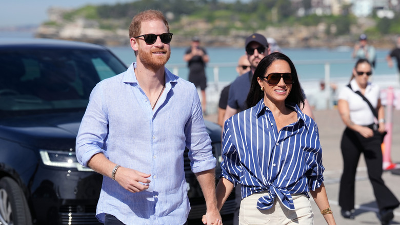 Prince Harry and Meghan Markle walk hand in hand