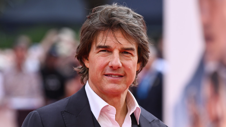 Tom Cruise smiles at a movie premiere