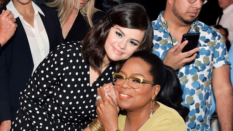 Selena Gomez and Oprah Winfrey posing for photos