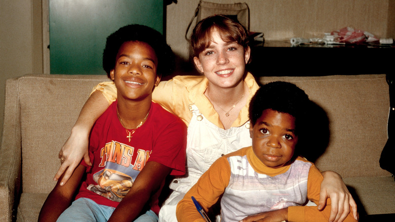 Todd Bridges, Dana Plato, and Gary Coleman posing on a couch