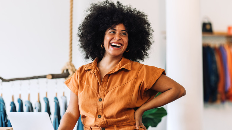 Woman smiling while working on laptop