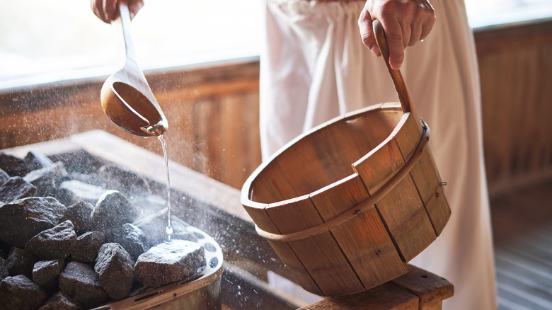 Pouring water on sauna rocks