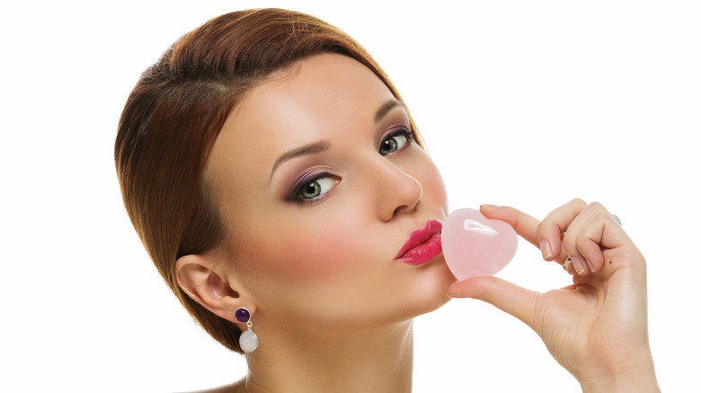 a woman holding rose quartz