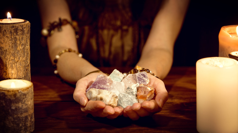 A person holding crystals 