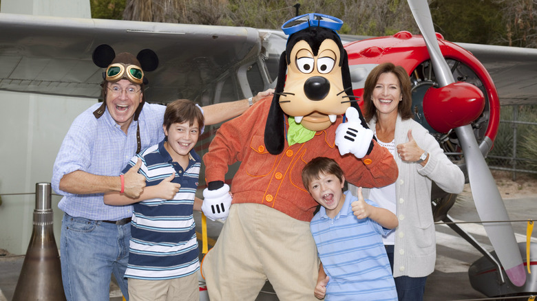 Stephen Colbert, wife Evelyn, and sons Peter and John pose with Goofy outside the Soarin Over California attraction at Disney California Adventure