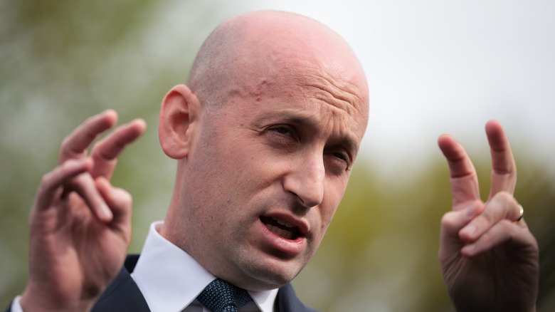 Stephen Miller doing bunny ears in a suit