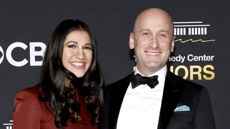 Katie and Stephen Miller smiling while posing together at a black-tie event