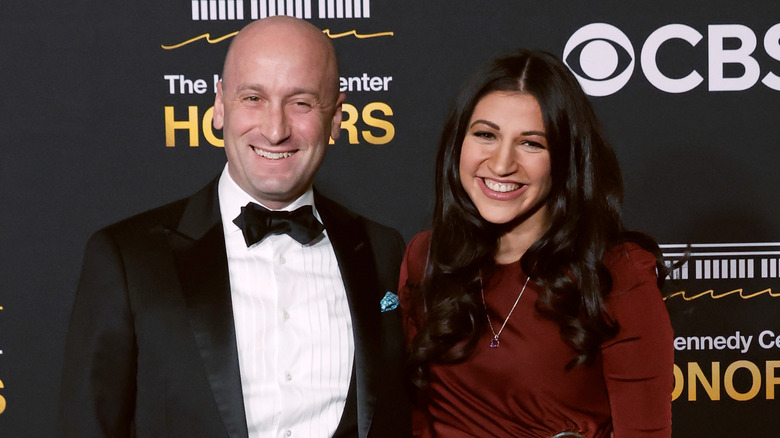 Katie and Stephen Miller smiling while posing at an event together