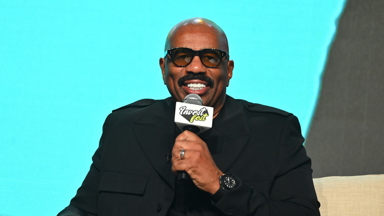 Steve Harvey talking into a microphone