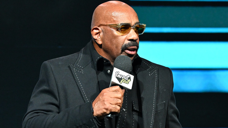 Steve Harvey speaking into microphone