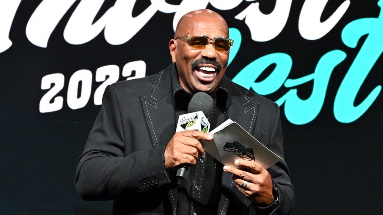 Steve Harvey smiling with microphone