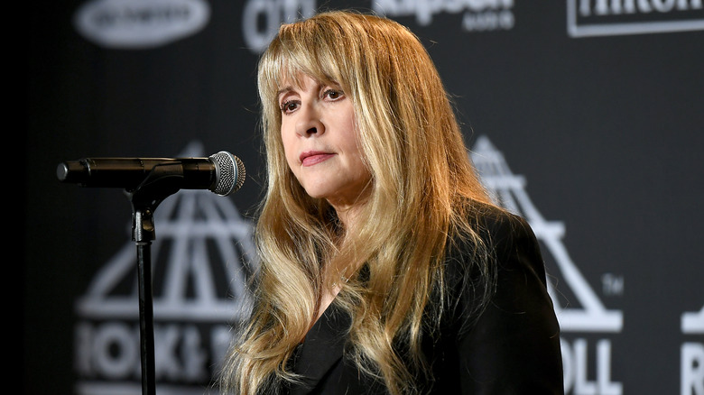 Stevie Nicks standing in front of microphone