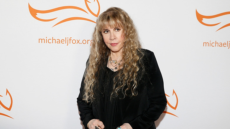 Stevie Nicks posing wearing all black at an event