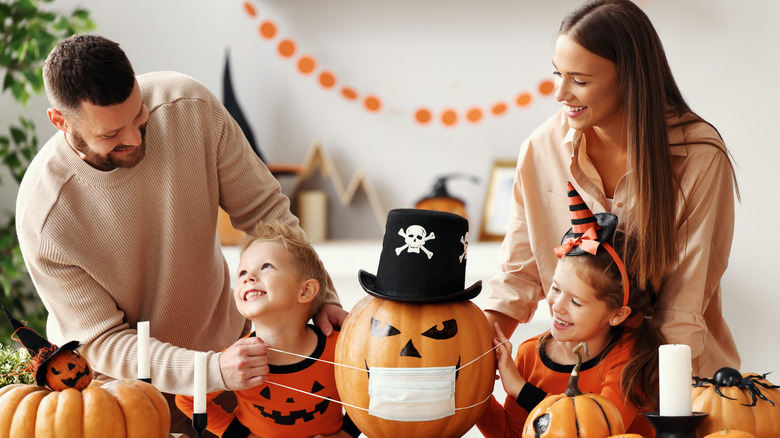 family laughing with Halloween decor