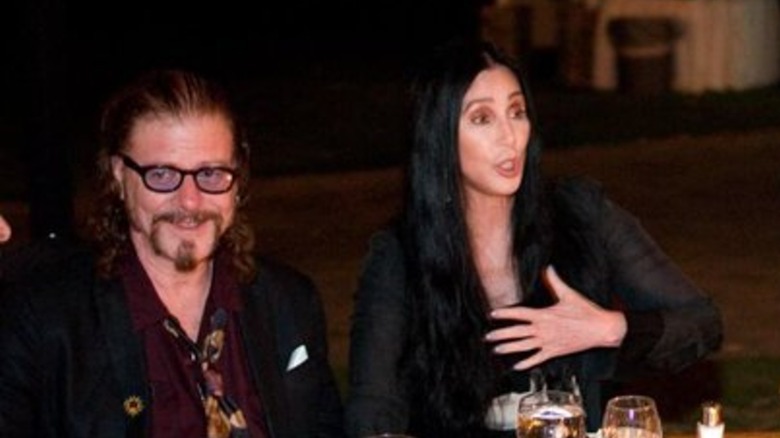 Cher and Ron Zimmerman sitting at a table