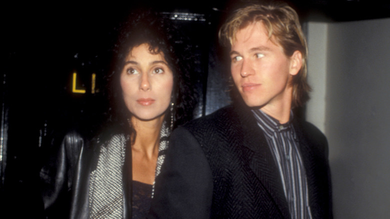 Cher and Val Kilmer posing in black