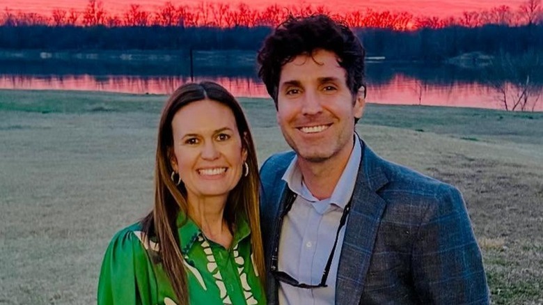 Sarah Huckabee Sanders and Bryan Sanders pose in front of a sunset in Arkansas (2025)