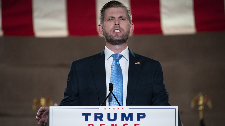 Eric Trump looking serious as he delivers a speech