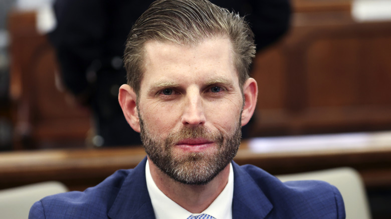 Eric Trump posing for the cameras in a courtroom