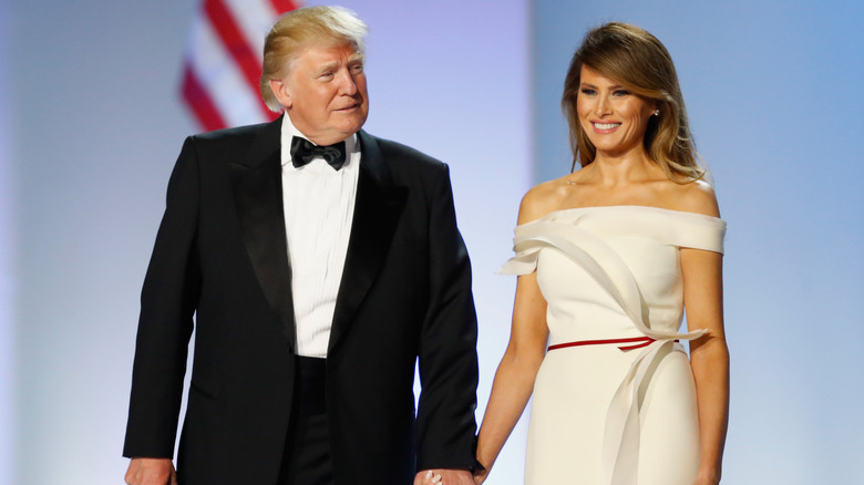 Melania Trump holding hands with Donald Trump