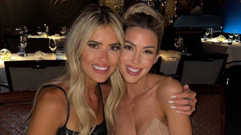 Christina Haack and Heather Rae El Moussa smiling and hugging