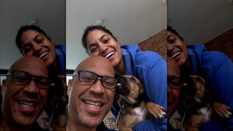 Alexis Lewis and Cory Booker take a selfie with a dog