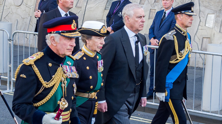 King Charles, Princess Anne, Andrew, and Prince Edward walking outside