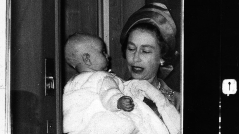 Queen Elizabeth II holding a baby Prince Edward