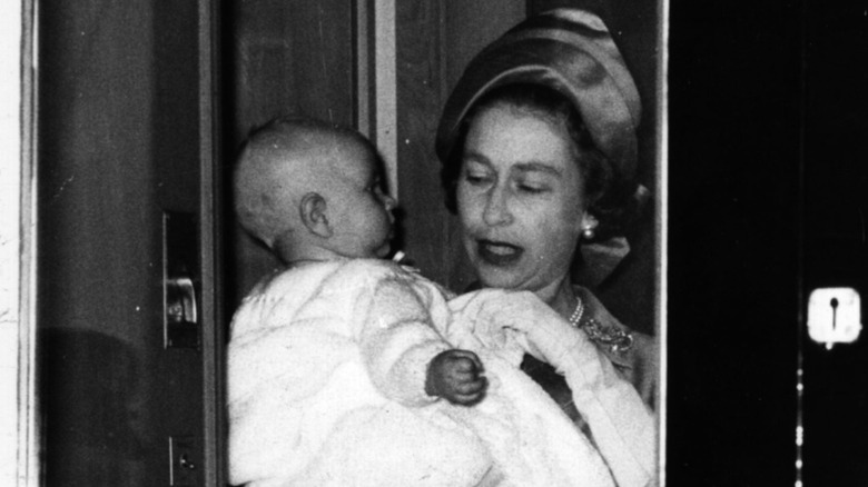 Queen Elizabeth II holding a baby Prince Edward