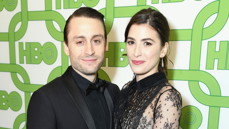 Kieran Culkin and Jazz Charton staning in front of white and lime green backdrop