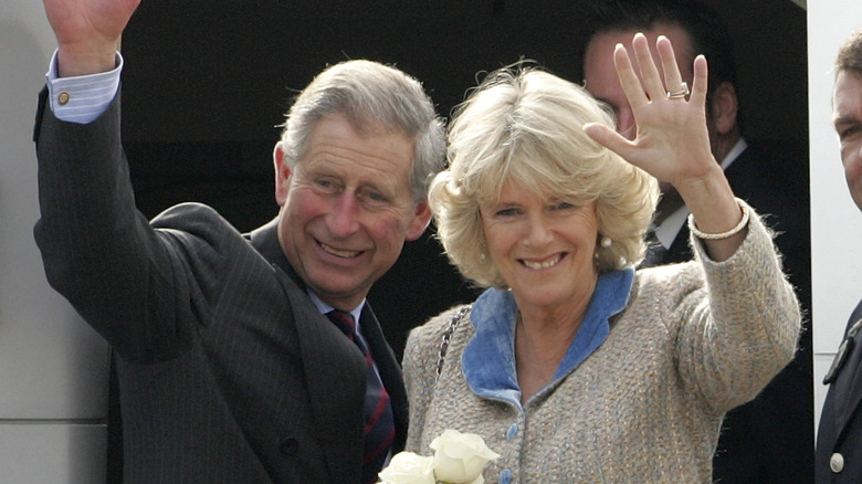 King Charles and Queen Camilla stepping onto a plane
